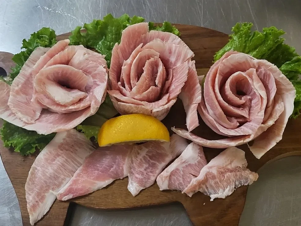 Pork belly rose presentation on wooden board