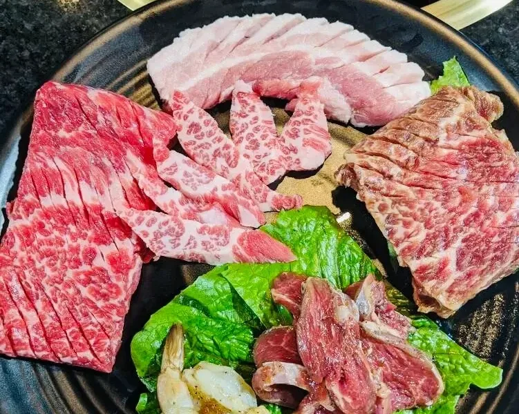 Assorted premium meat cuts on Korean BBQ grill